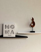 Black and white slim metal wall shelves with book and sculpture