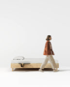 Nightstand attached to wooden bed shown in side view
