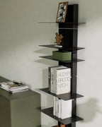Black modular wall shelf with books and storage box