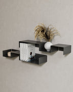 Black modular wall shelves with books, vase, and bowl