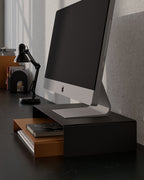 Black metal monitor stand with lower shelf for keyboard notebook or desk items storage