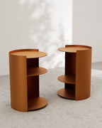Terracotta metal nightstands with open side shelves on concrete floor