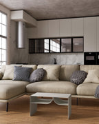 white metal coffee table with built-in book rack in front of beige sofa
