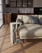 white metal side table with open book rack beside sofa