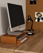 Orange metal monitor stand with lower shelf for keyboard notebook or desk items storage