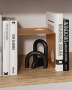 terracotta metal bookend used as book support on wooden shelf