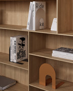 Orange metal bookend on wooden shelving with books nearby