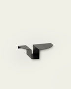 Black metal nightstand on light background