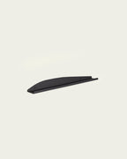 Black slim metal wall shelf on light background