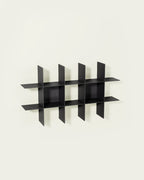 Black modular wall shelf on light background
