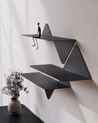 black modular wall shelves mounted above console with vase