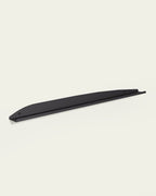 Black slim metal wall shelf on light background
