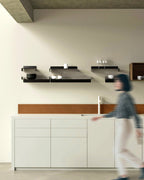 Black metal wall shelves in different sizes above kitchen counter