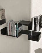 Black modular wall shelf with books in stepped arrangement