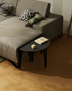 Black modular coffee table used as a side table next to sofa
