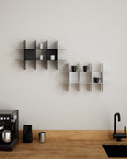 Black and white modular wall shelves in kitchen with mugs