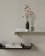 White and black metal wall shelves with vase and books