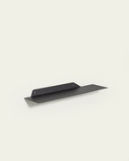 Black slim metal wall shelf 60 cm on light background