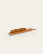 Terracotta slim metal wall shelf 60 cm on light background