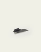 Black slim metal wall shelf 30 cm on light background