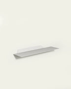 White slim metal wall shelf 60 cm on light background